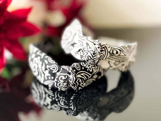 Black and white paisley knot headband, front view