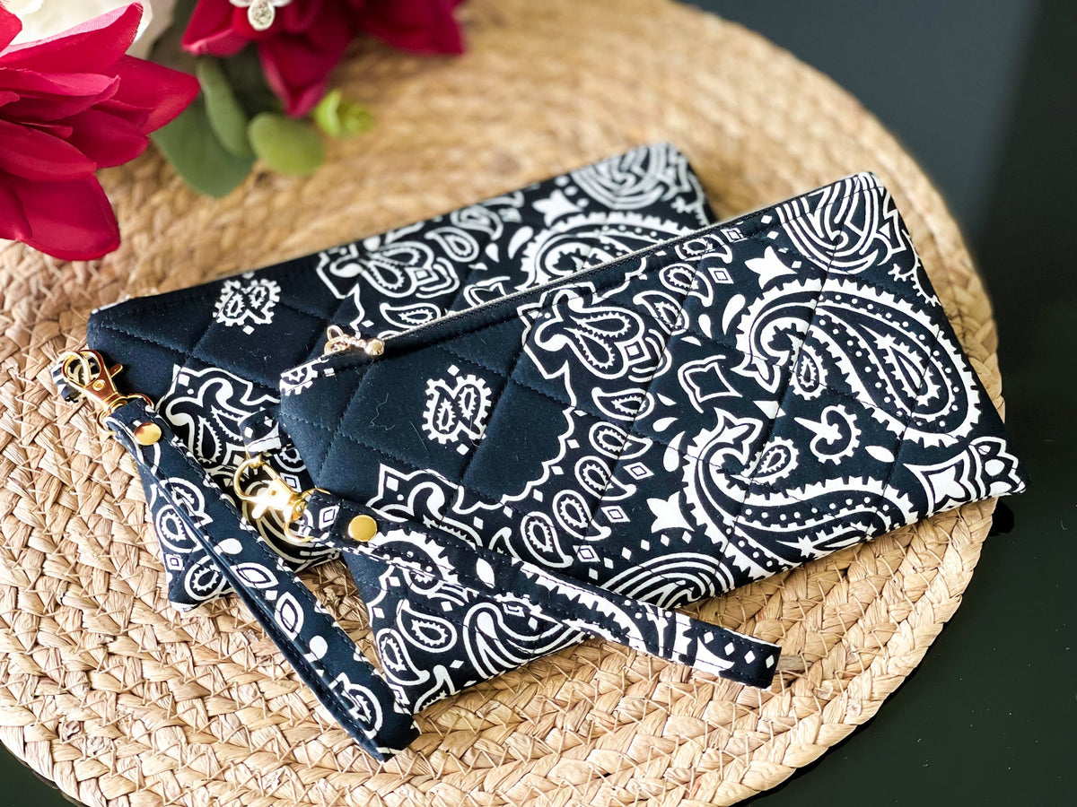 Quilted wristlet pouch, dark navy with white paisley print and gold zipper pull