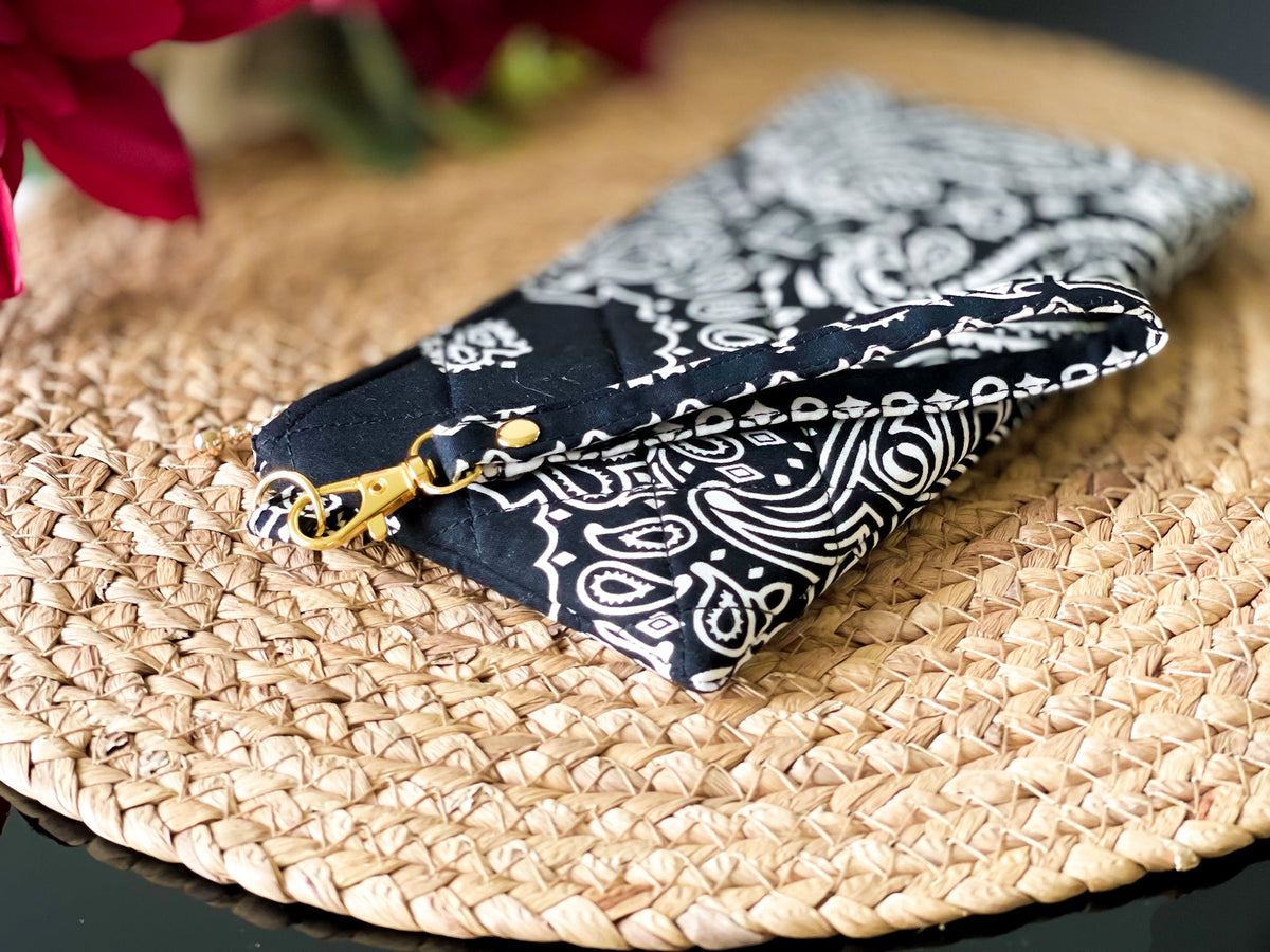 Quilted wristlet pouch corner view, navy and white paisley pattern with gold hardware