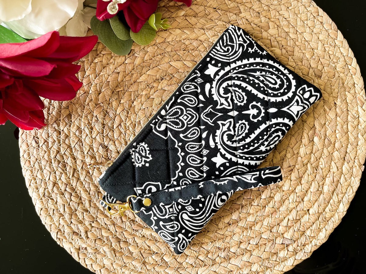 Quilted wristlet pouch, navy with white paisley motifs, gold zipper pull and chain strap