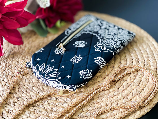 Diplomat phone sling crossbody with gold chain strap, black bandana print pouch