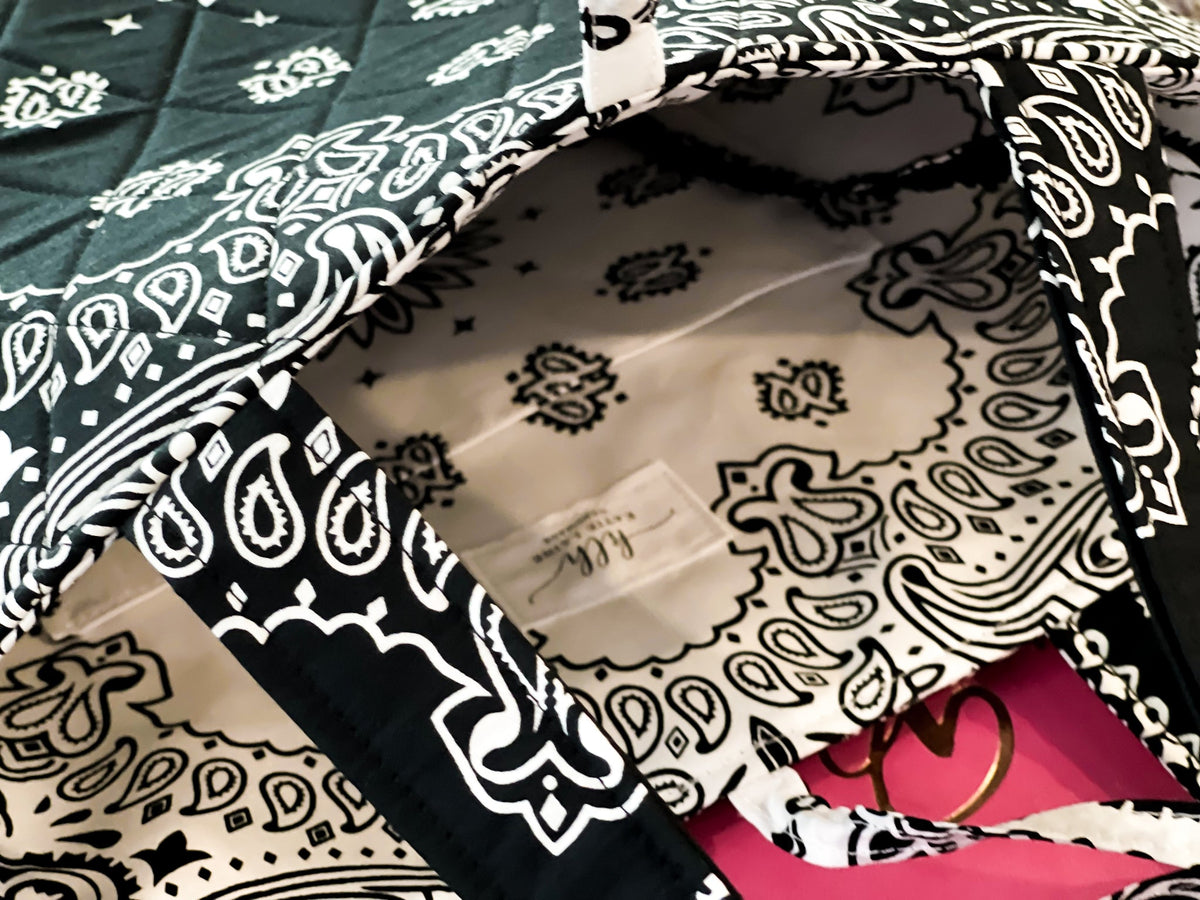 Interior of black-and-white paisley tote bag showing stitched lining and open top
