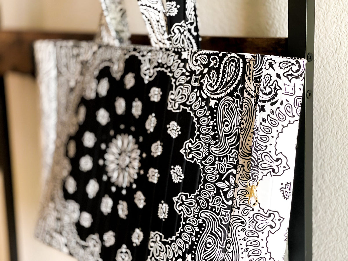 Quilted tote bag fabric close-up, black-and-white paisley print and handle