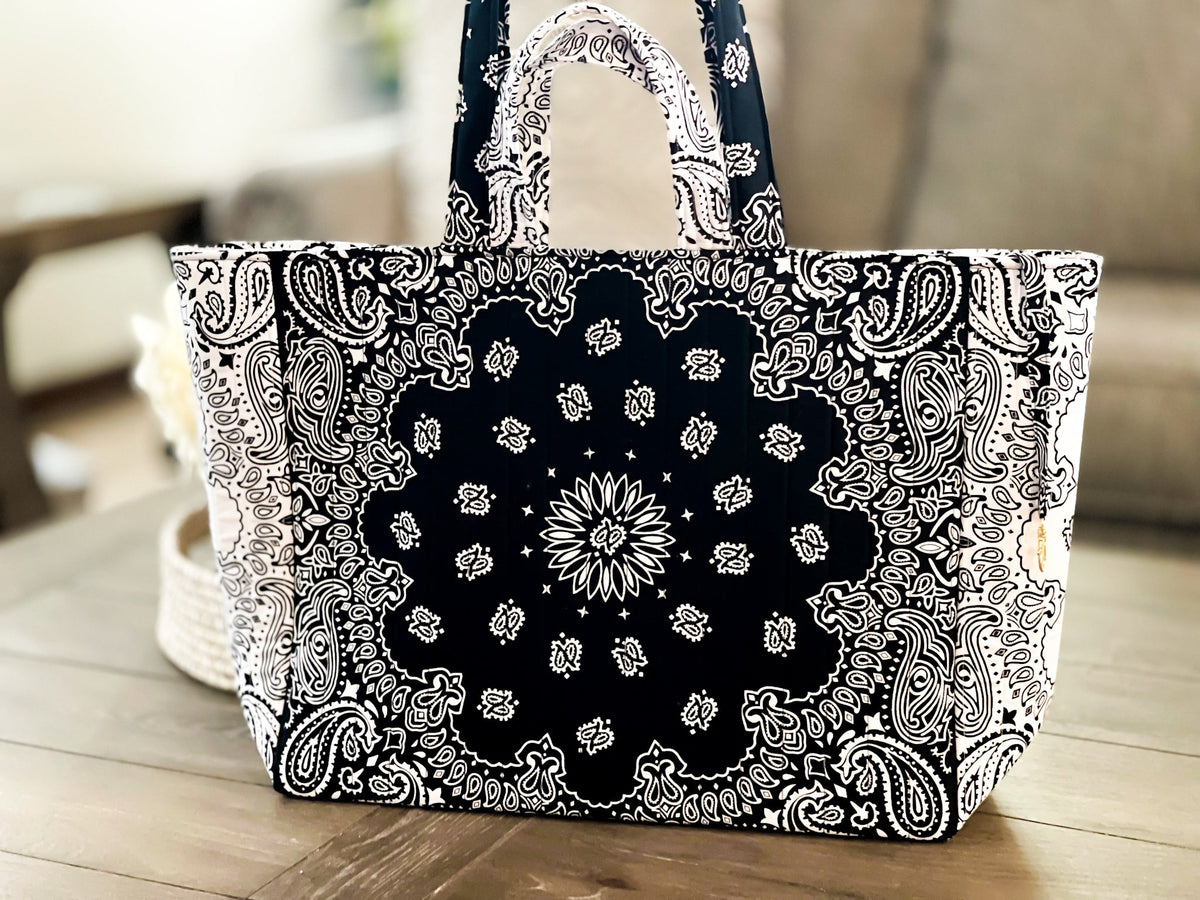 Large quilted tote bag, black-and-white paisley print, front view on floor