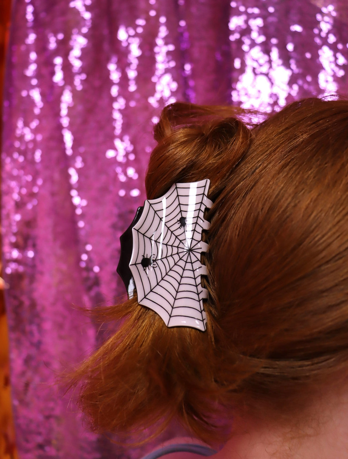 Spider-web hair claw clip in white and black, clipped in brown hair