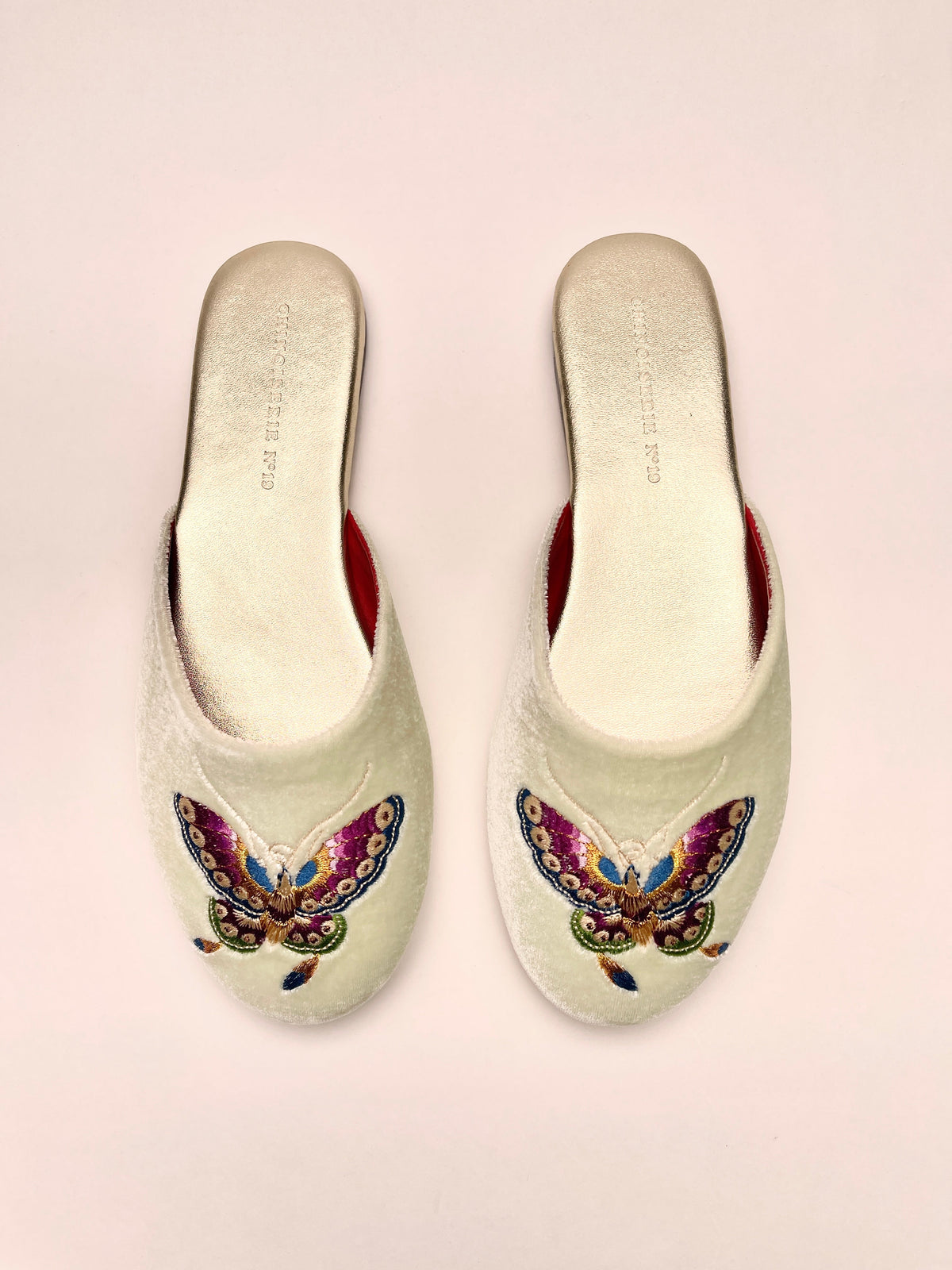Pair of mint velvet mules with colorful butterfly embroidery, red inner lining