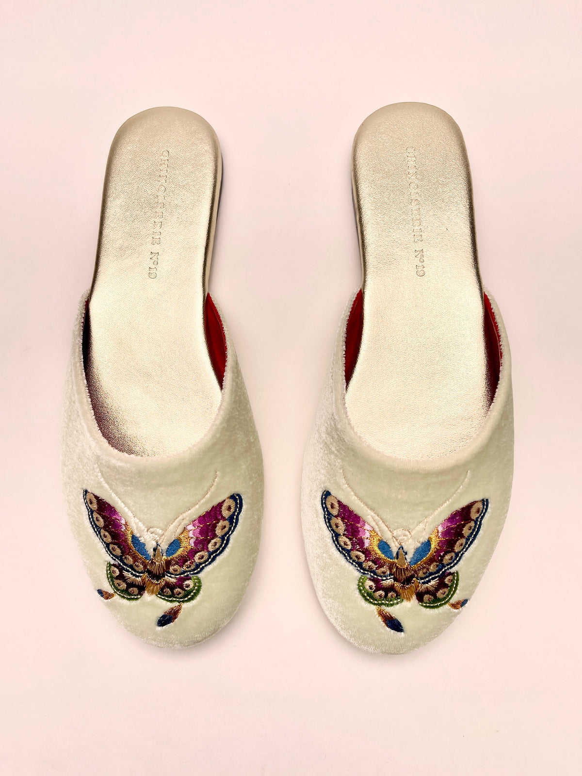 Mint velvet mules with butterfly embroidery on front, red lining, slip-on design