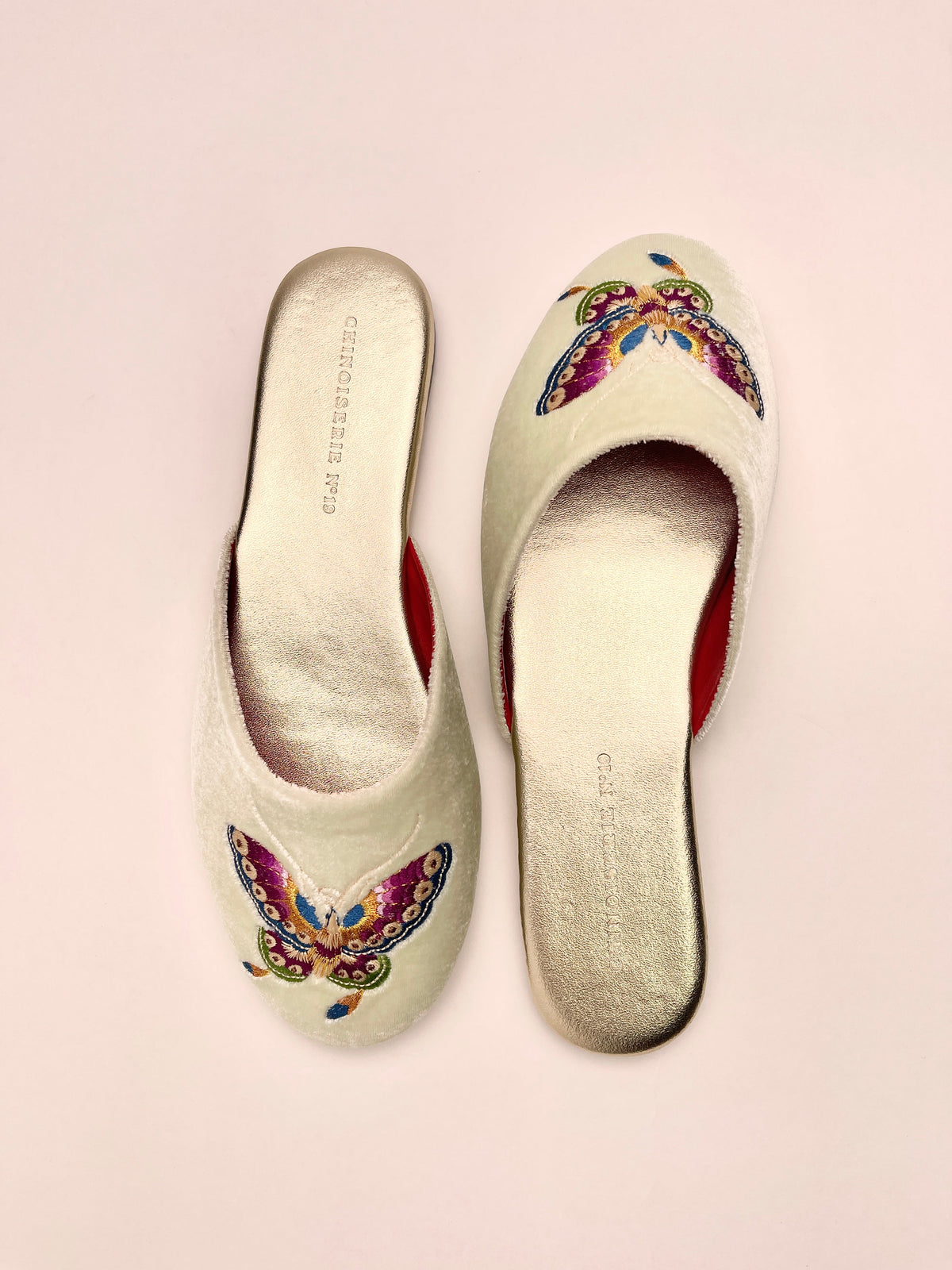 Mint velvet mules with colorful butterfly embroidery on toes, red inner lining