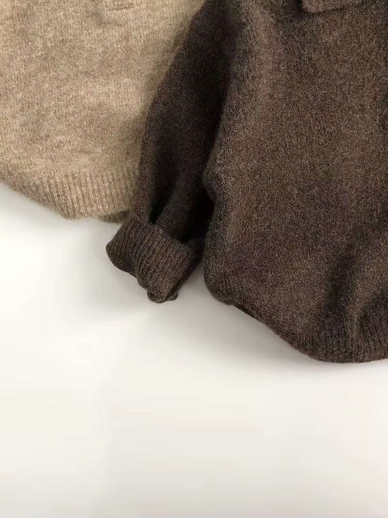 Close-up of knit toddler sweater cuffs and button placket in tan and dark brown