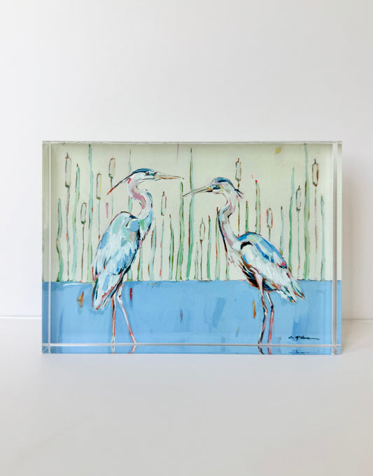 Tabletop acrylic art panel with two blue herons standing by tall reeds and blue water