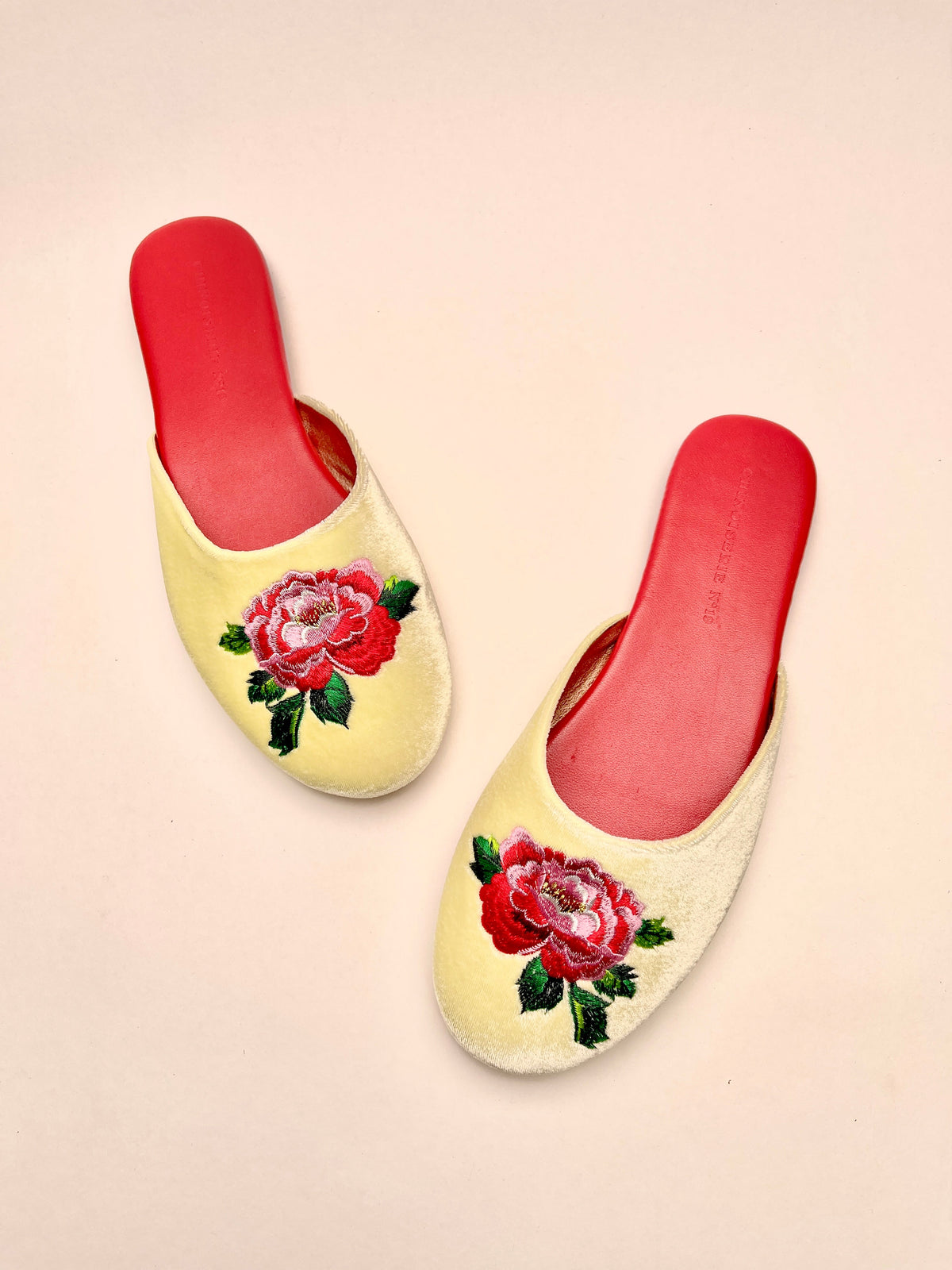Pair of lemon velvet mules with peony floral embroidery and red interior, slip-on