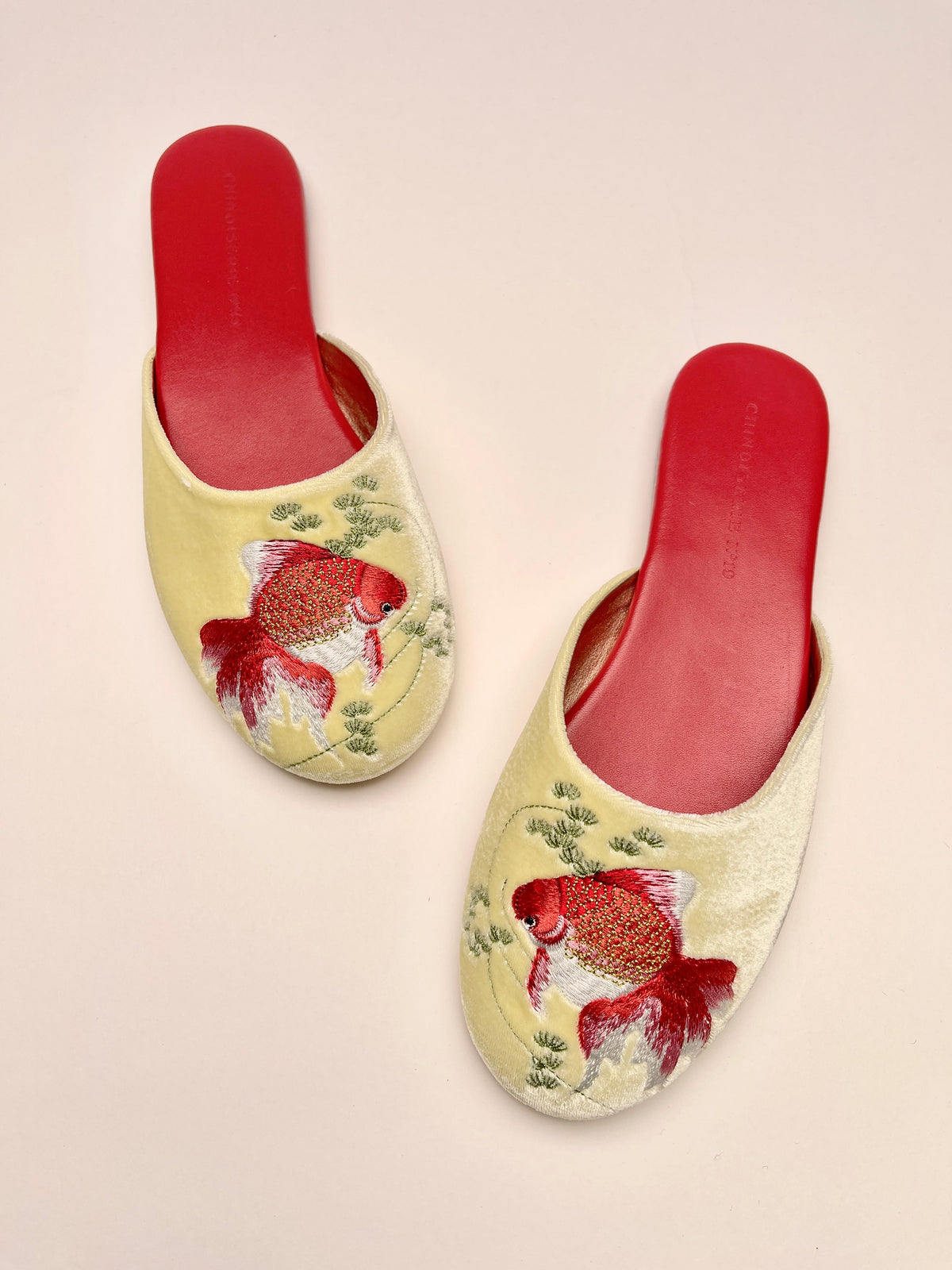 Goldfish-embroidered velvet mules in lemon with red slip-on lining