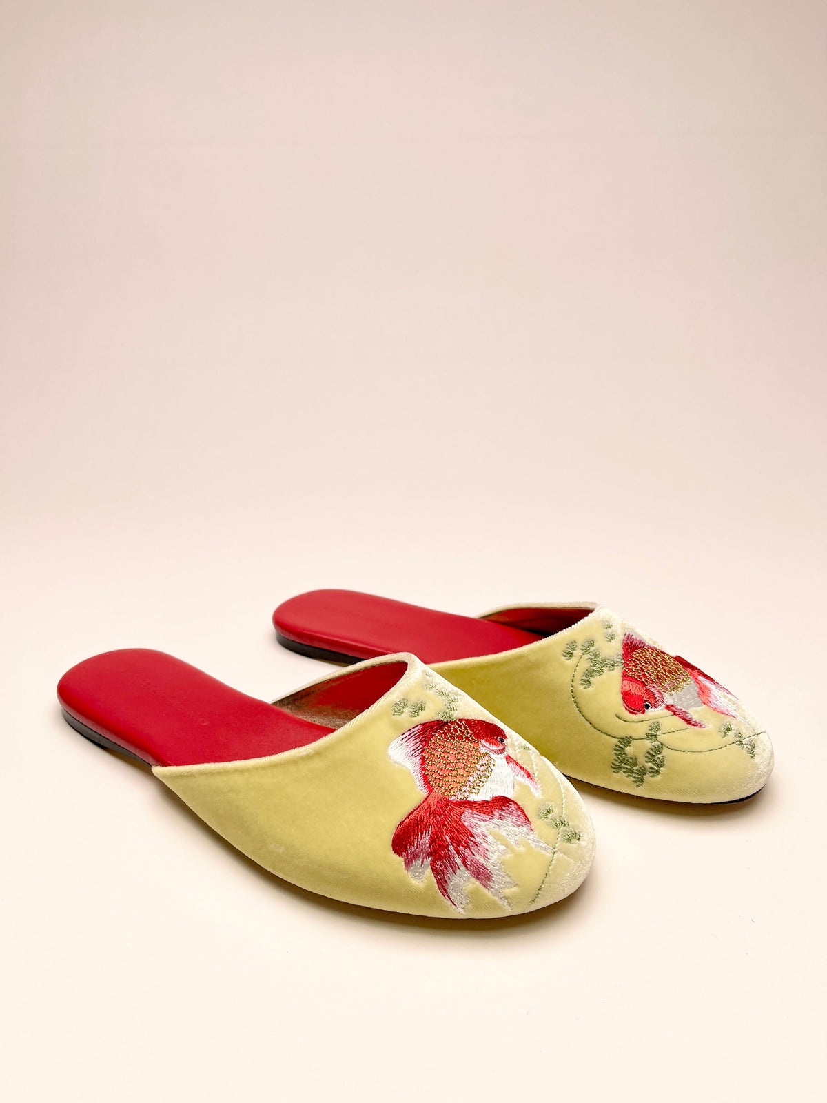 Red-and-lemon velvet mules with goldfish embroidery on the front
