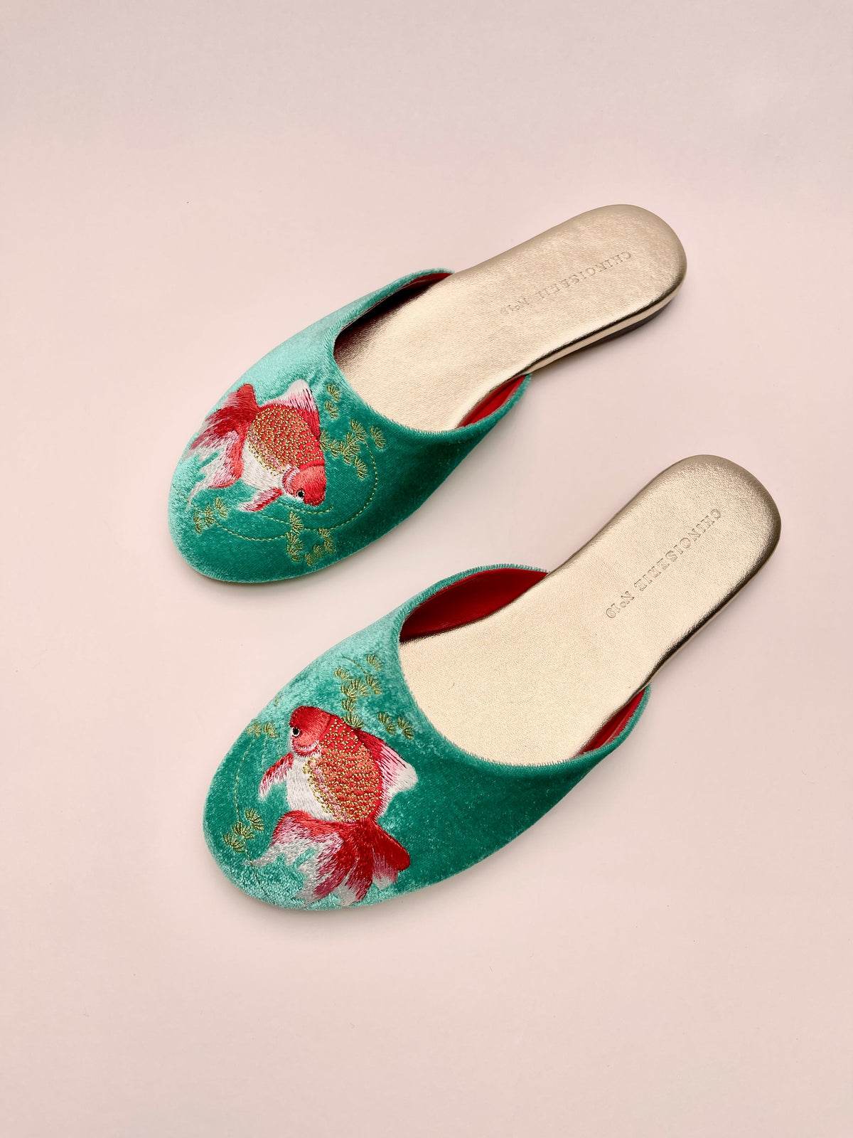 Jade velvet mules, angled view with goldfish embroidery on front
