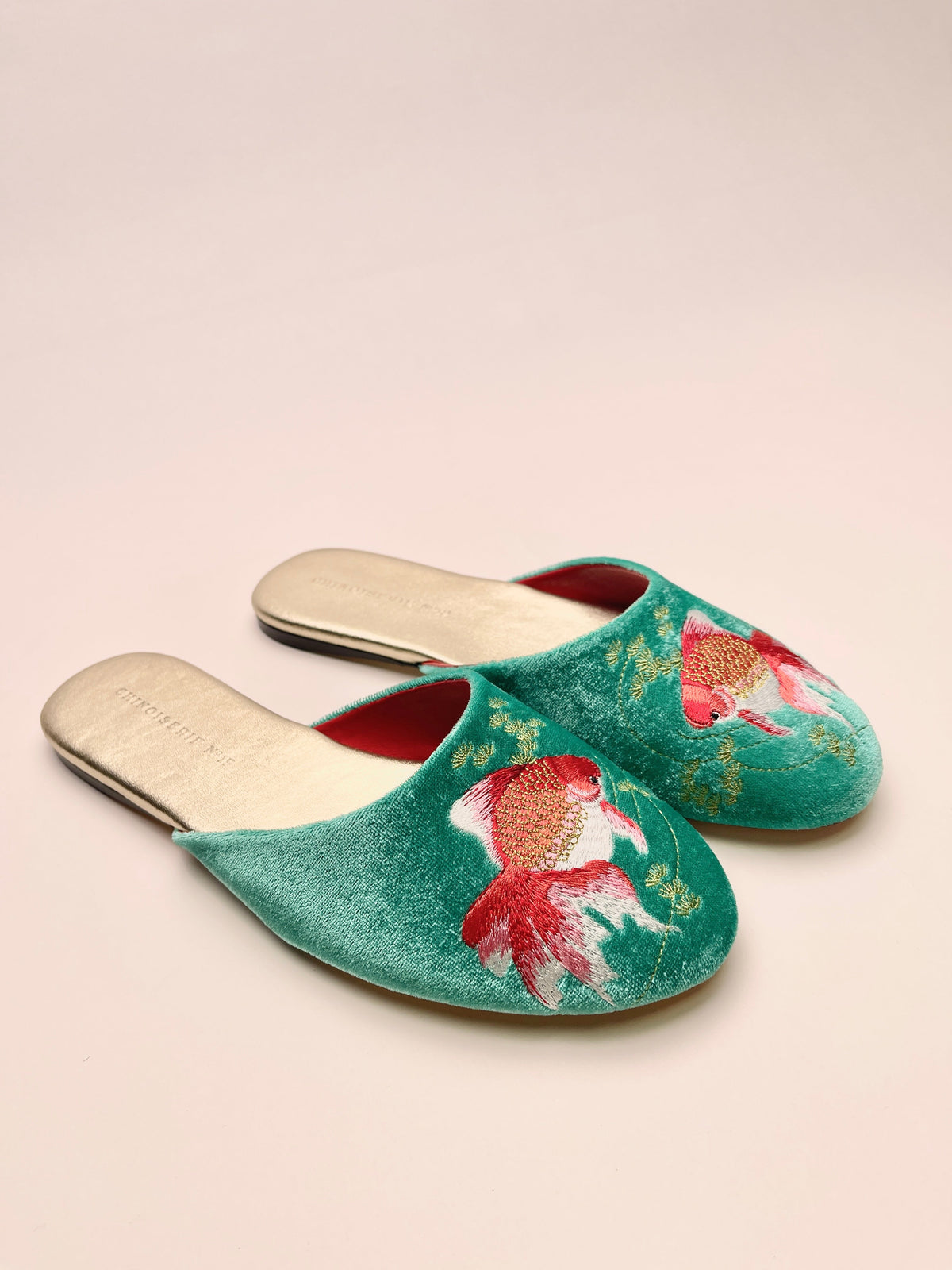 Jade velvet mules with goldfish embroidery, showing two-tone soles