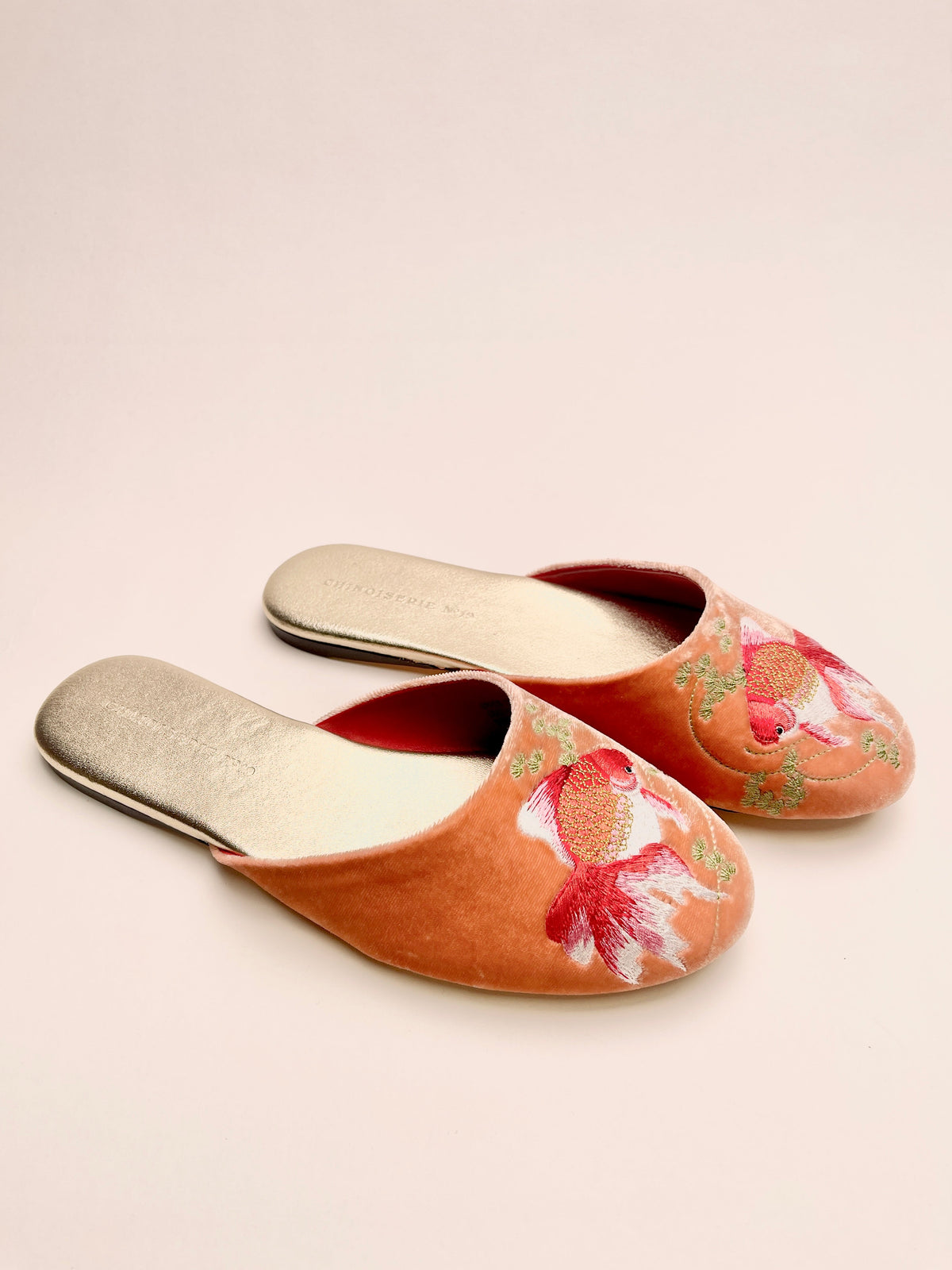 Peach velvet mule slippers with goldfish embroidery, contrasting red lining, laid-back pair