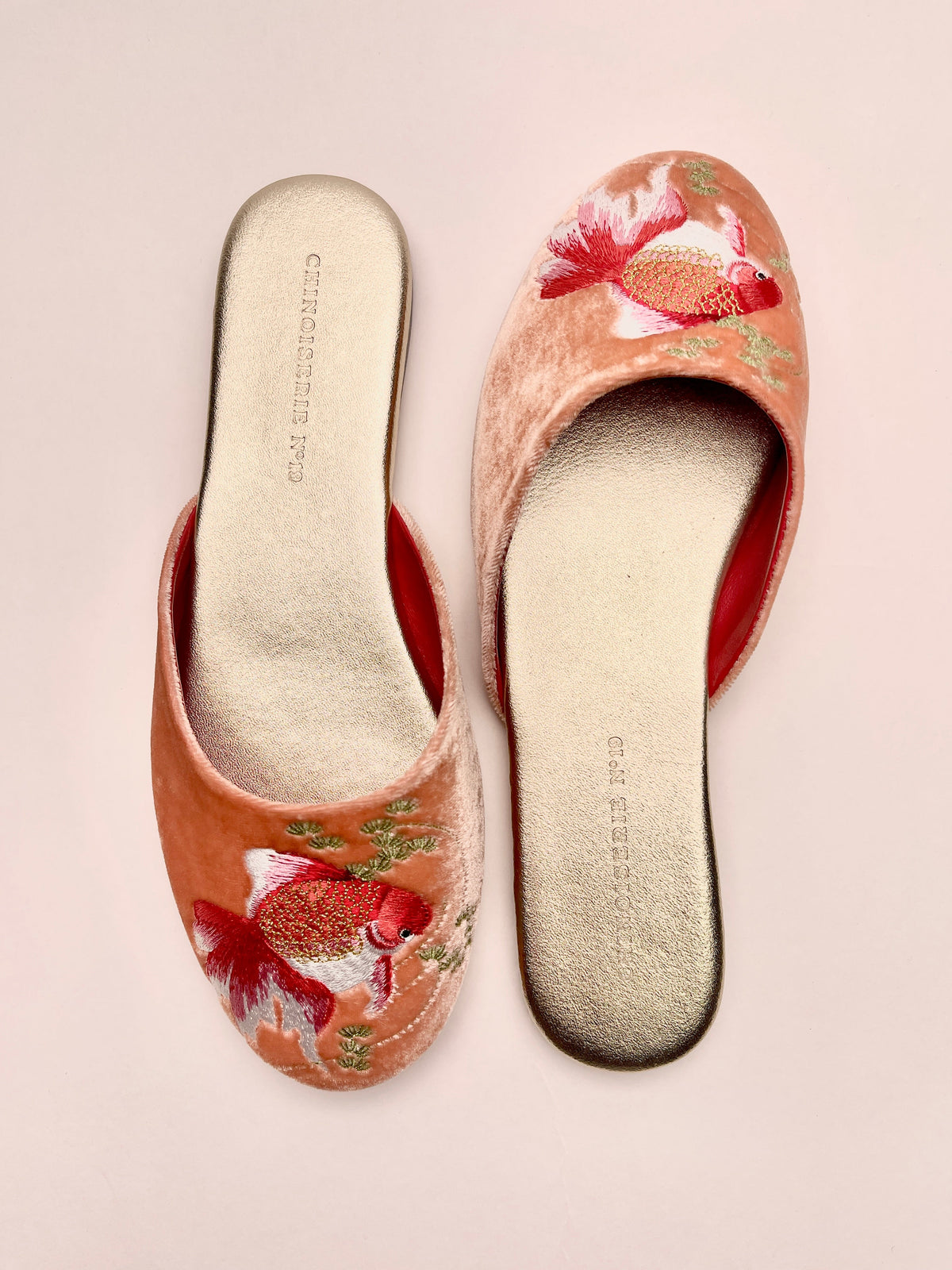 Peach velvet mule slippers with goldfish embroidery, red trim, showing suede insoles