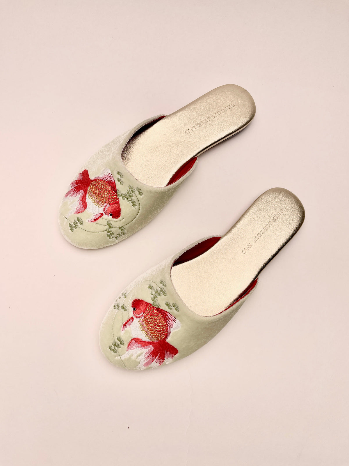Pair of mint velvet mule slippers with goldfish embroidery on rounded toe