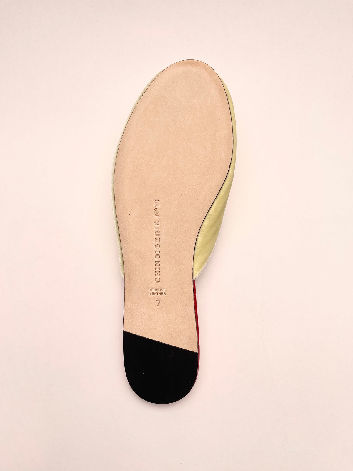 Lemon velvet mule insole with black outsole at the heel