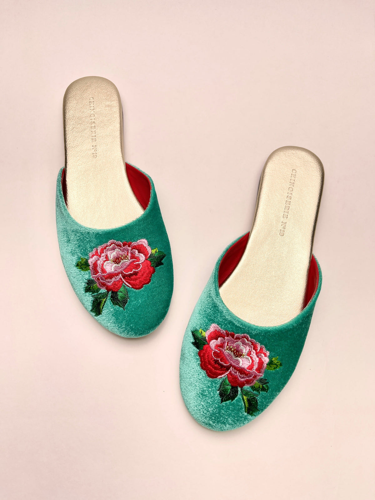 Jade green velvet mules with peony floral embroidery and red inner lining