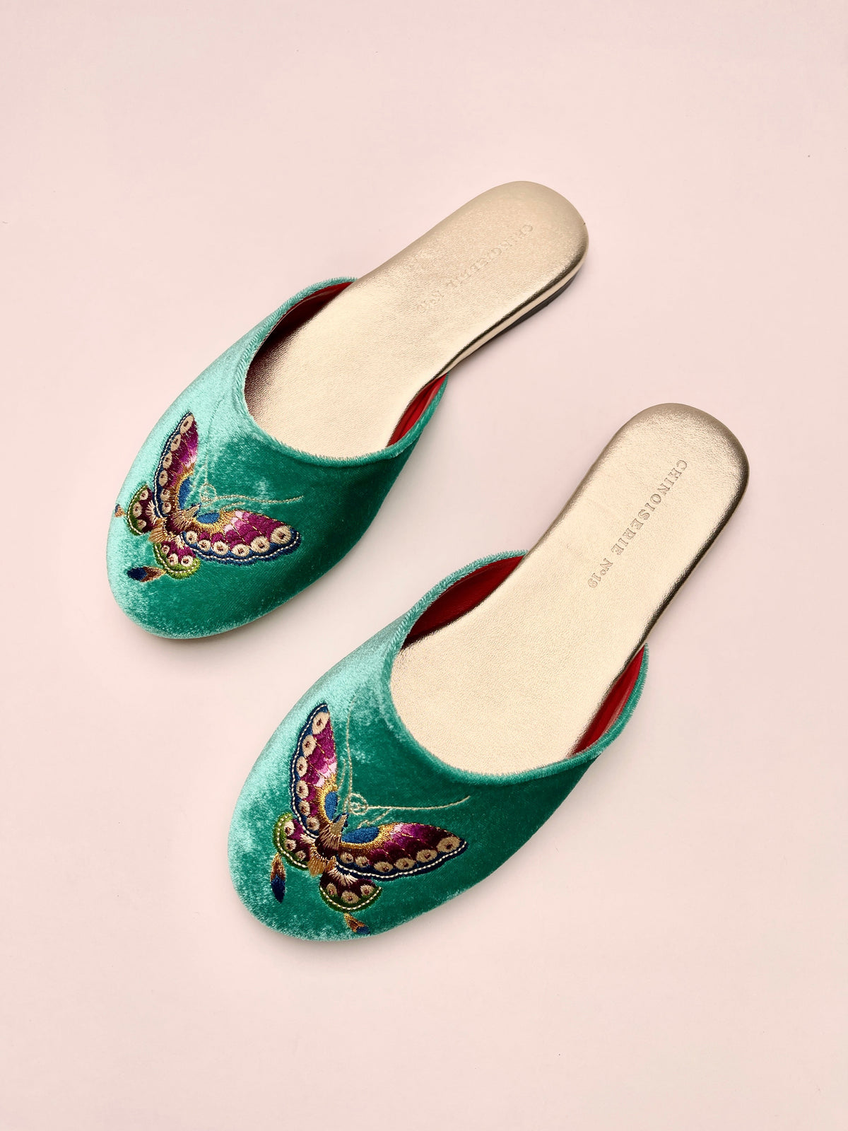 Jade green velvet mule slippers with butterfly embroidery, rounded toe, red inner lining.