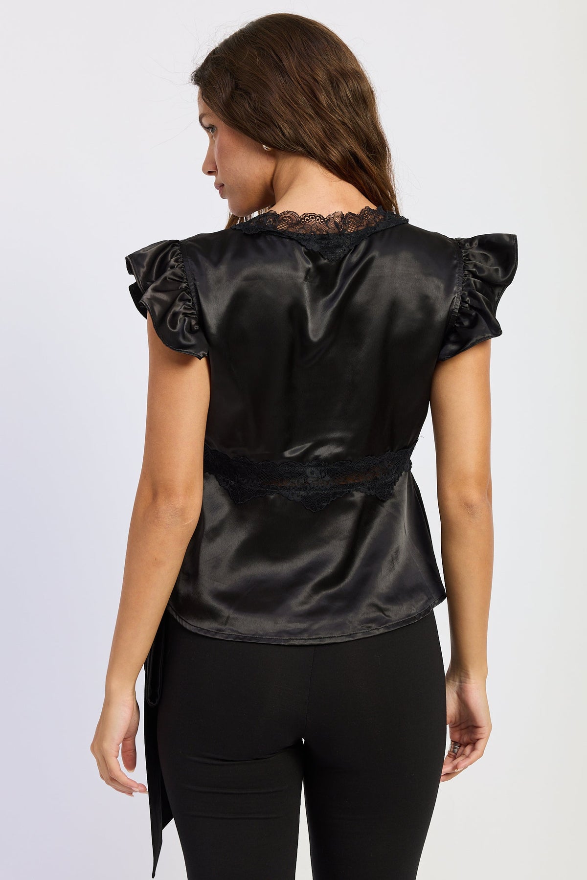 Aliza black satin top, back view, ruffled shoulder sleeves and peplum hem