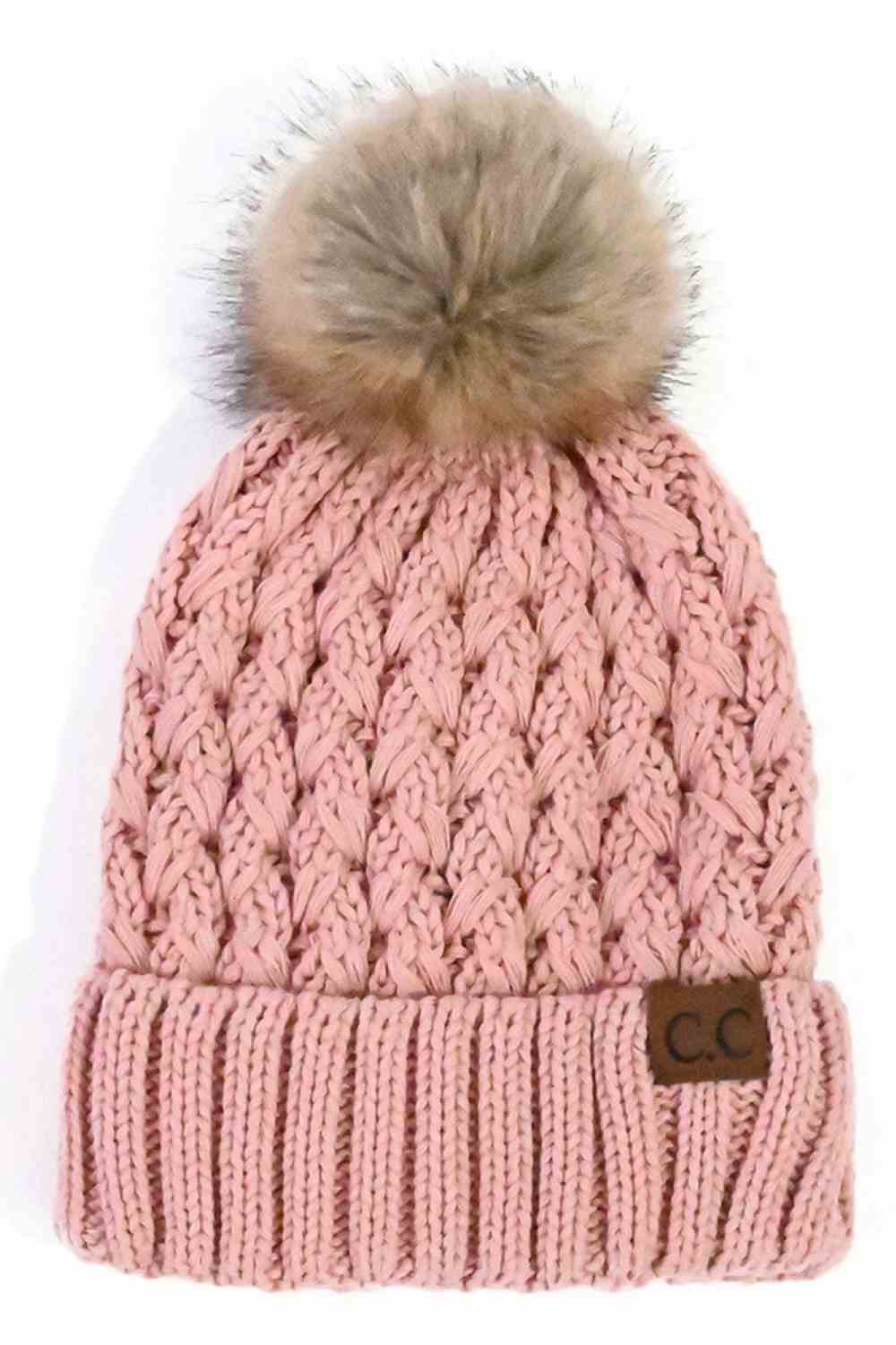 Pink knitted beanie with fluffy pom-pom and C.C patch on ribbed cuff.