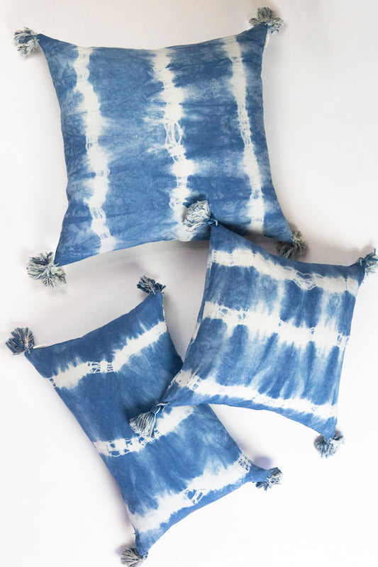 Indigo shibori throw pillows with tassels, blue-and-white striped tie-dye