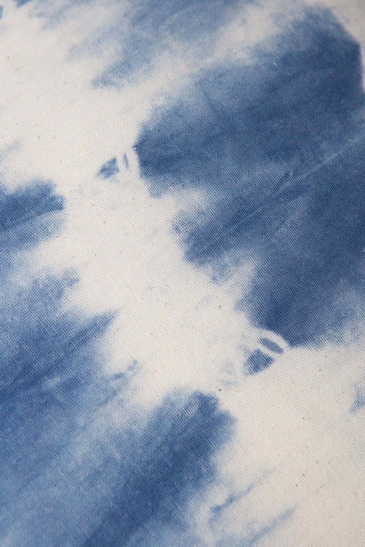 Indigo shibori tie-dye fabric close-up with white streaks