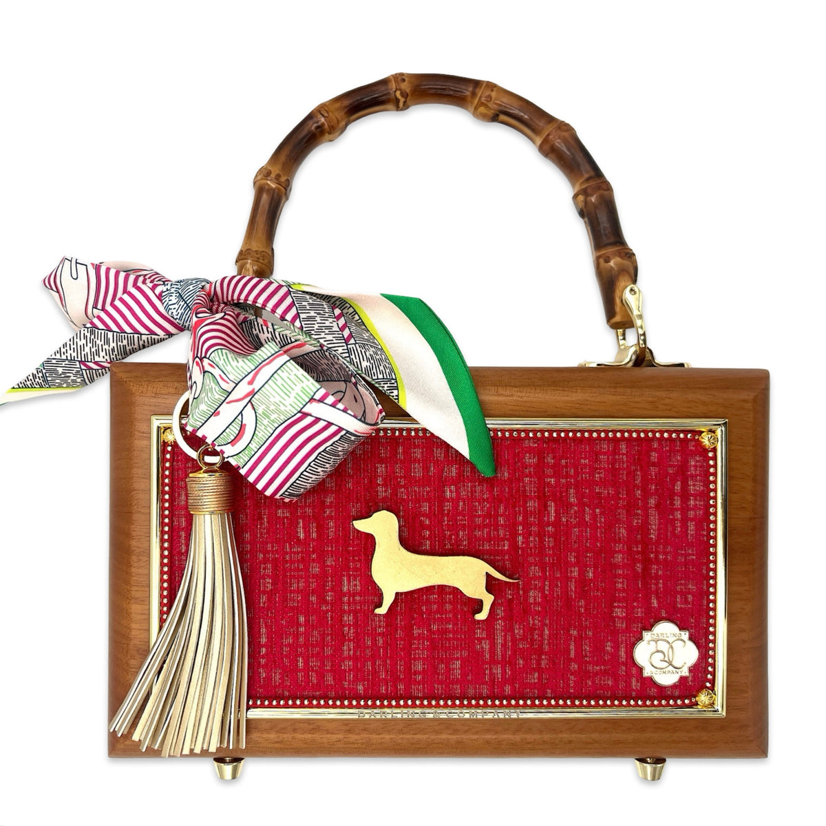 Wood-framed doxie bag with red fabric front, gold dog charm, bamboo handle