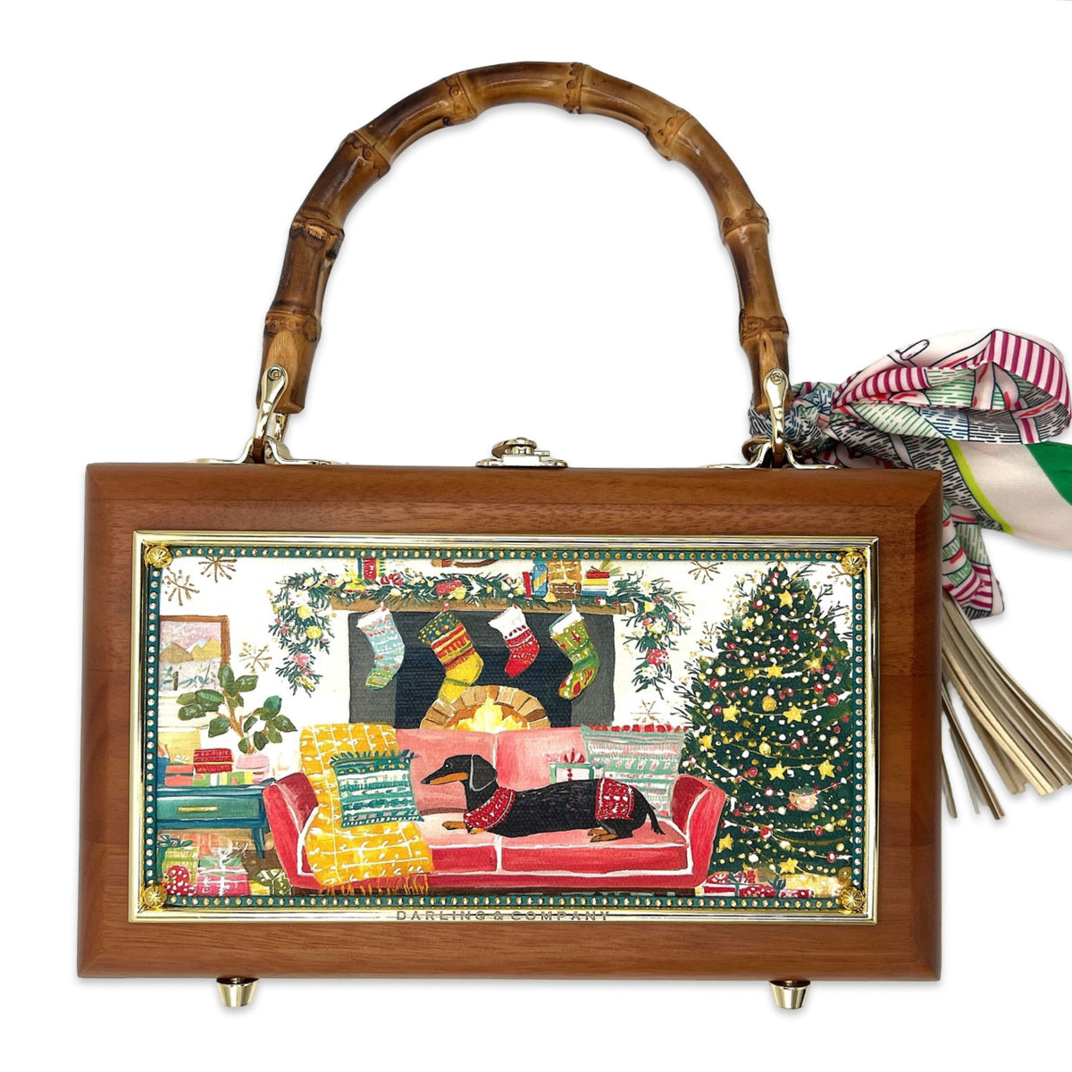 Wood-framed doxie bag with bamboo handles and festive illustrated front panel