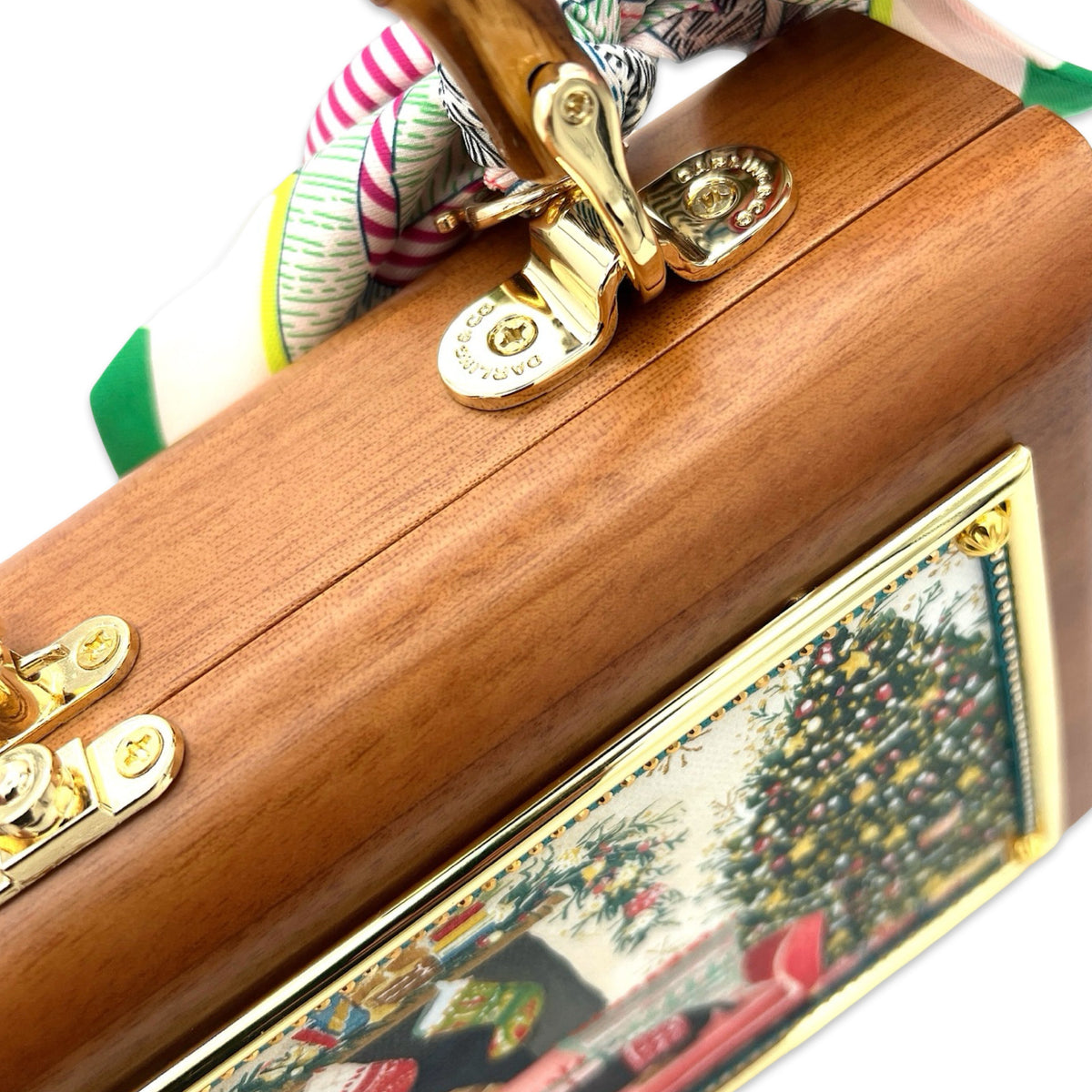 Gold clasp and bamboo handle on wooden doxie bag with patterned trim edge