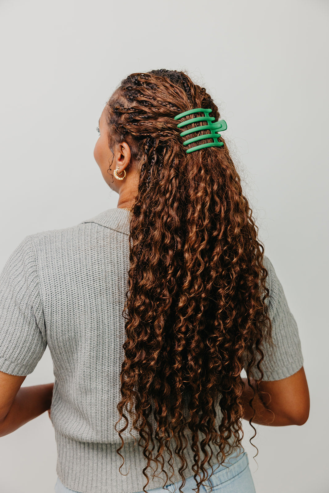 Wide hair claw clip in teal green on long curly brown hair