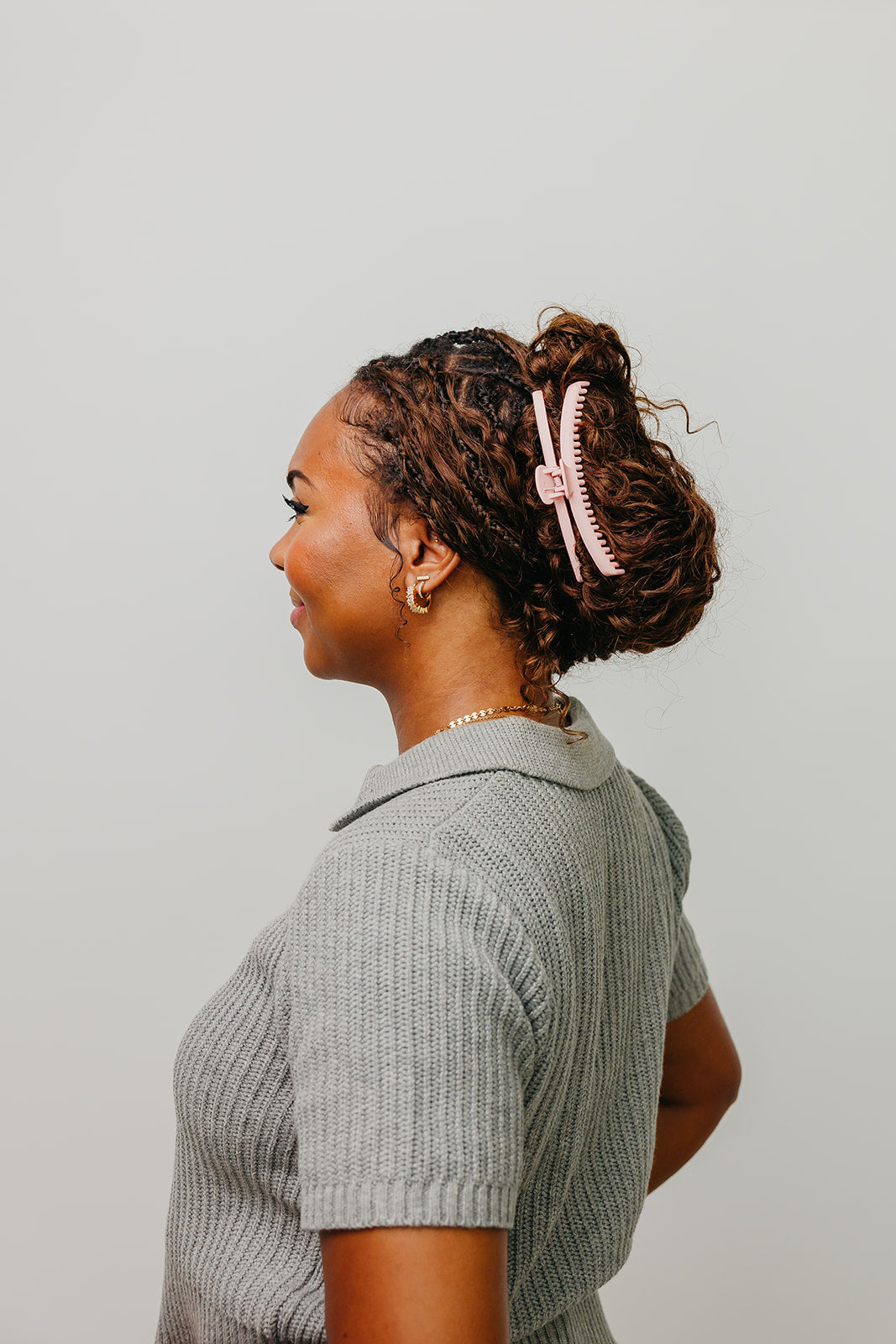 Light pink hair claw clip in dark hair, side view