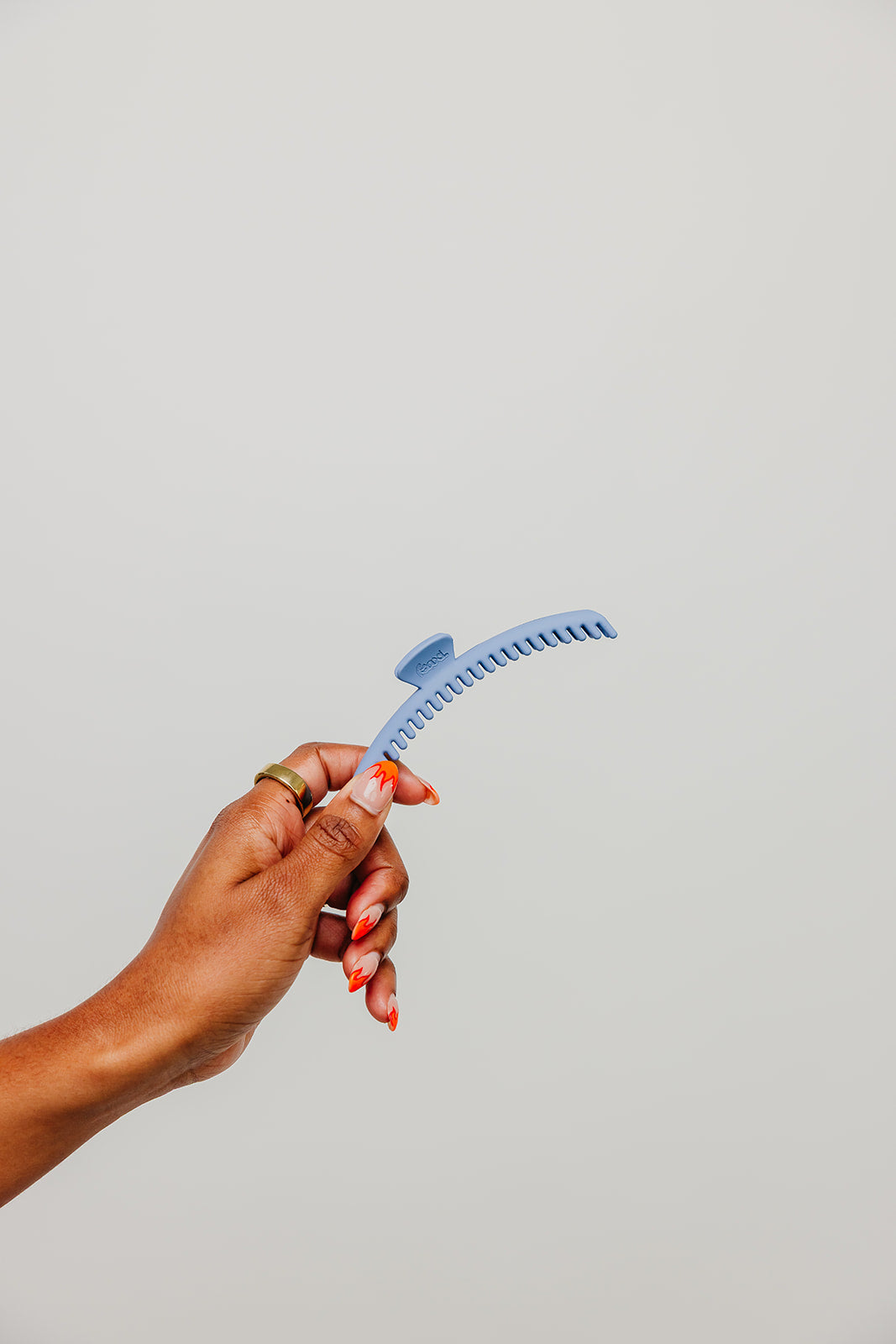 Light blue matte claw hair clip held in hand