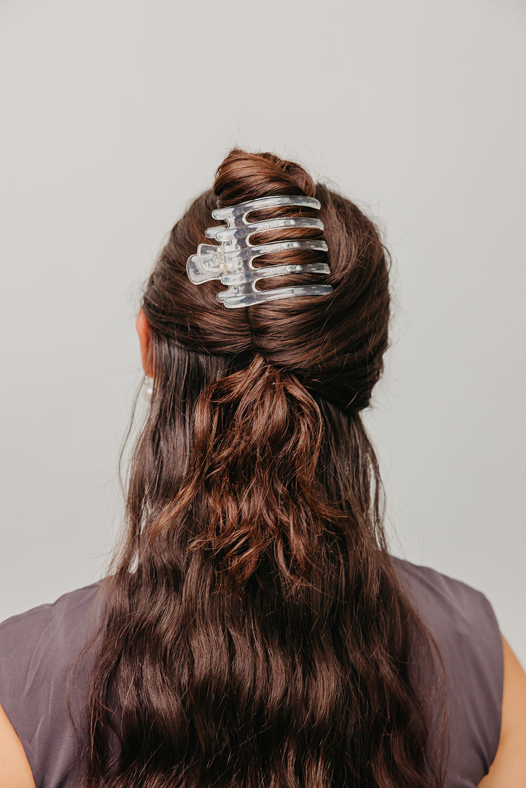 Wide lay-down claw hair clip, translucent clear with wide claw teeth.