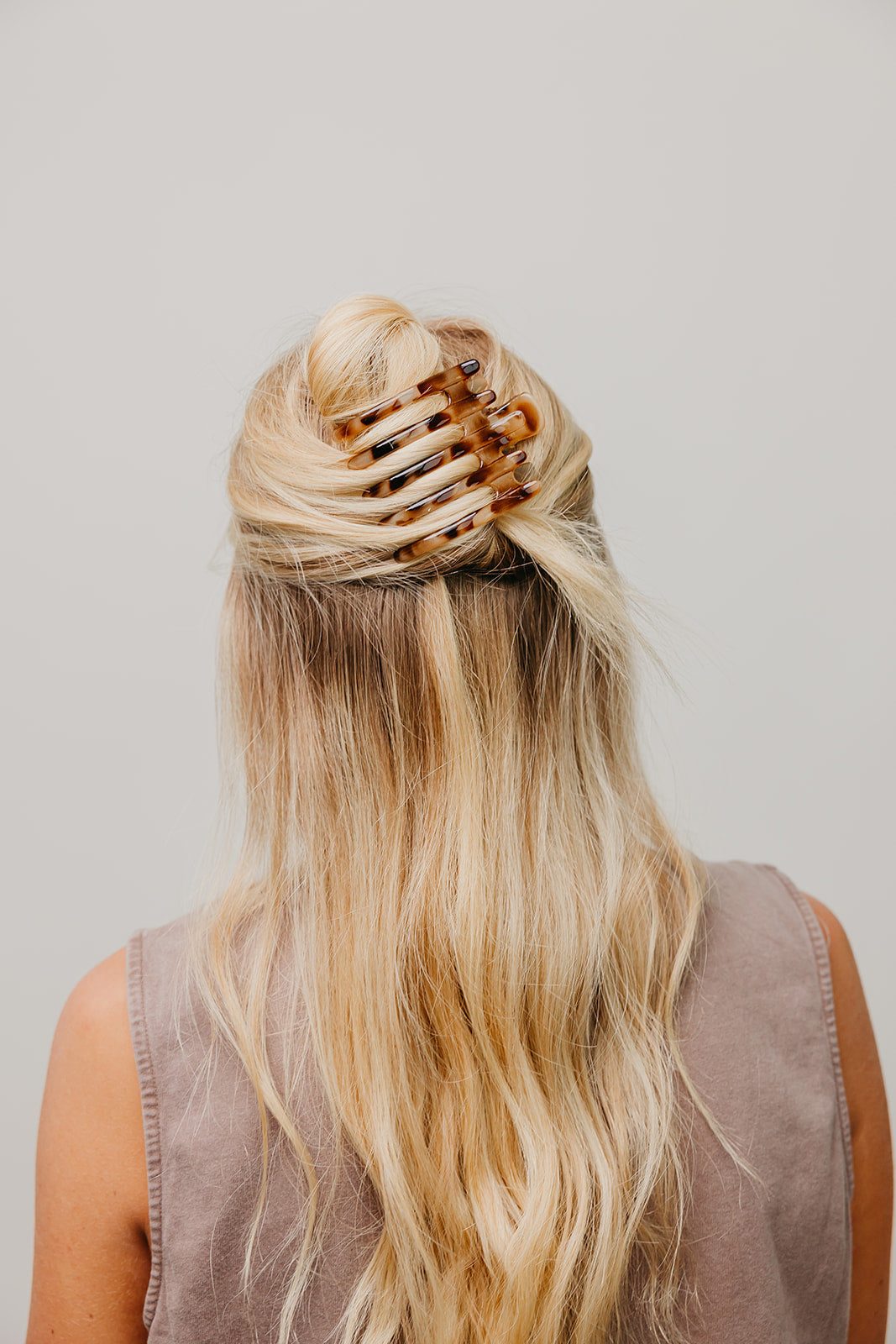 Wide hair claw clip in warm caramel-brown tortoise finish
