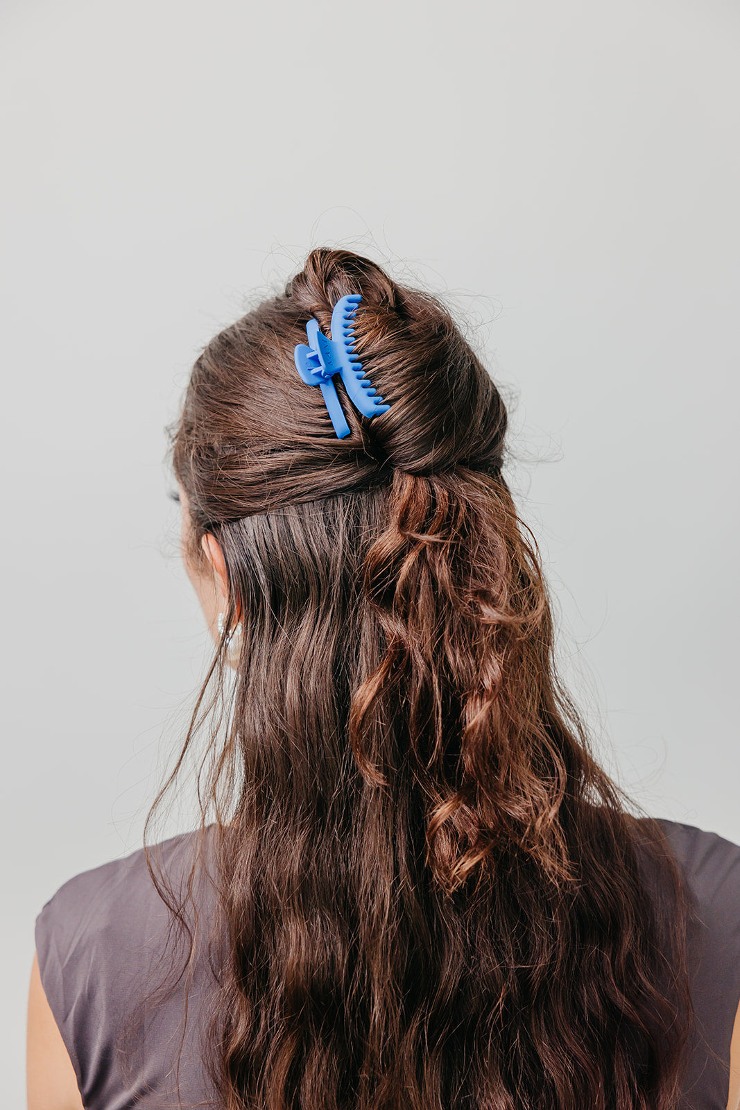 Matte mini claw hair clip, blue, on brunette hair updo