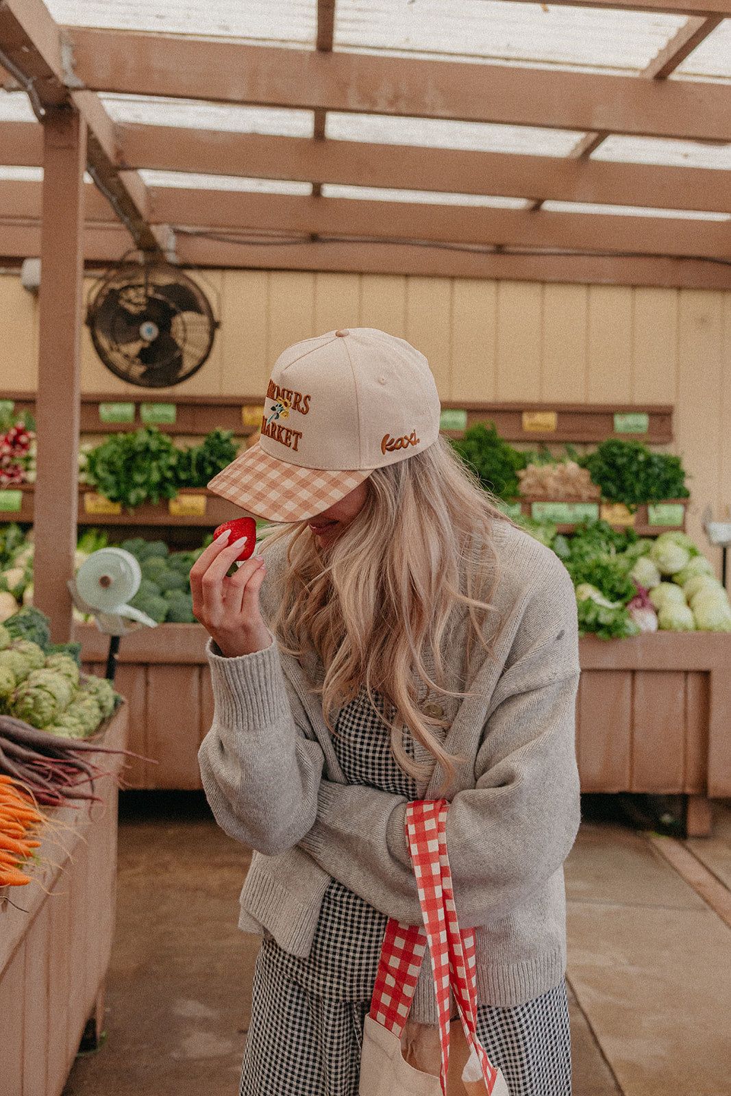 Beige trucker hat with Farmers Market embroidery and orange gingham brim