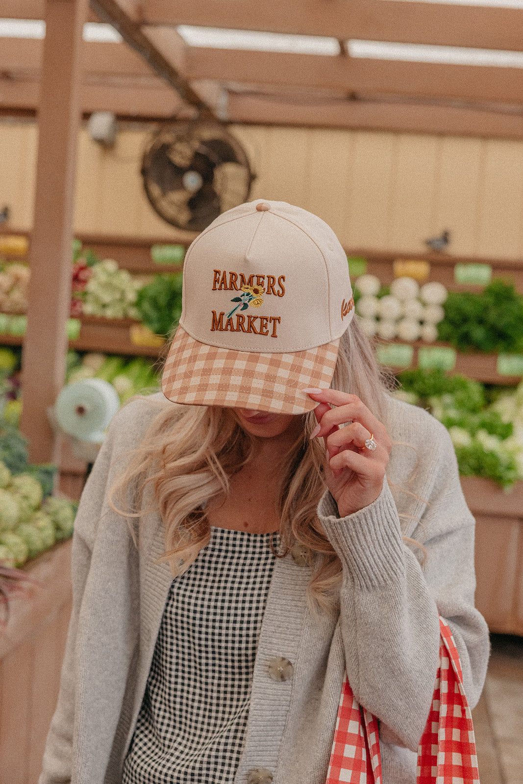 Light beige trucker hat with Farmers Market embroidery and orange-and-white gingham brim