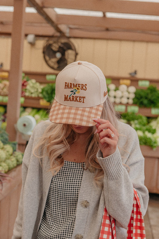 Light beige trucker hat with Farmers Market embroidery and orange-and-white gingham brim