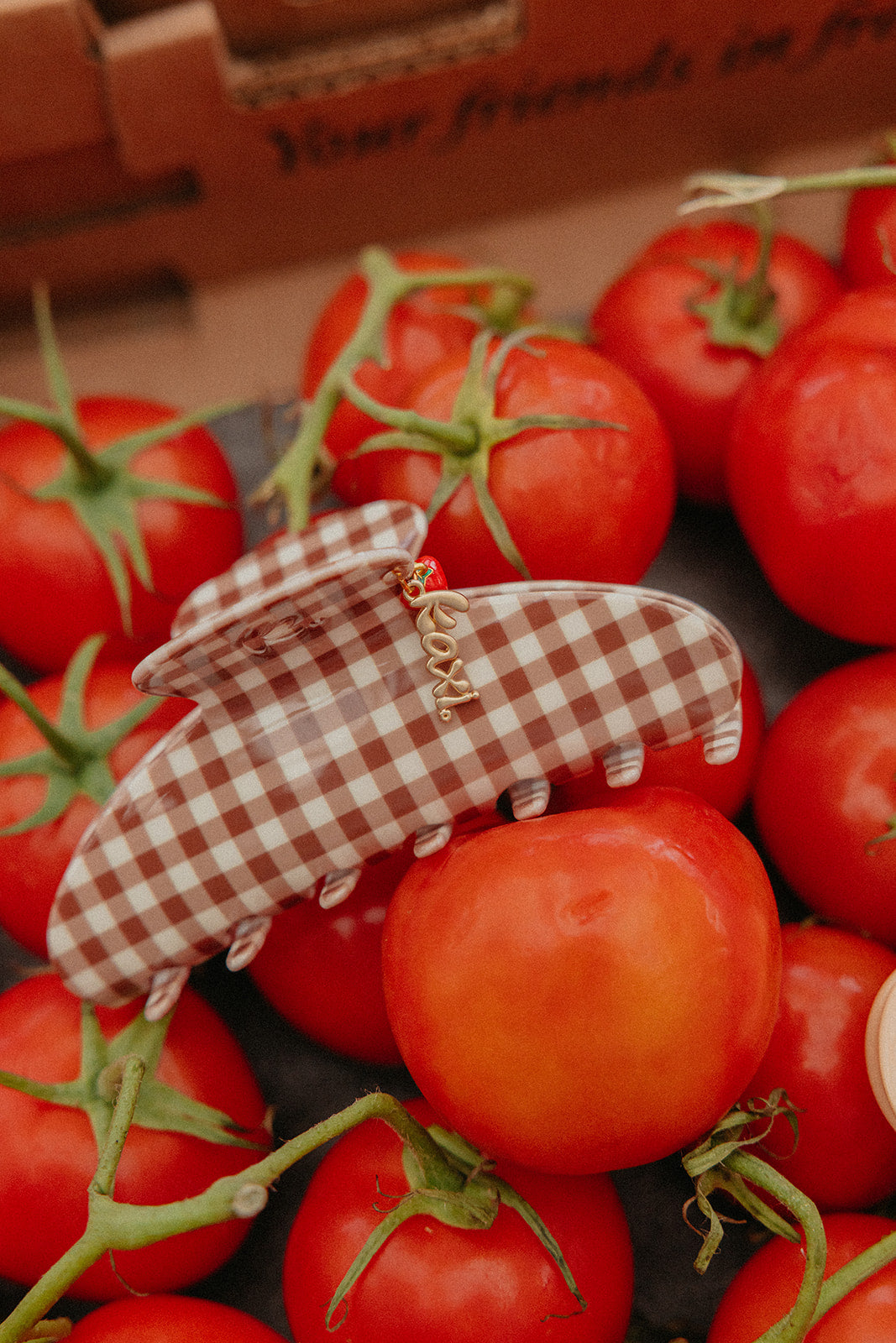 Brown gingham hair claw with red tomato charm and dangling gold-tone chain