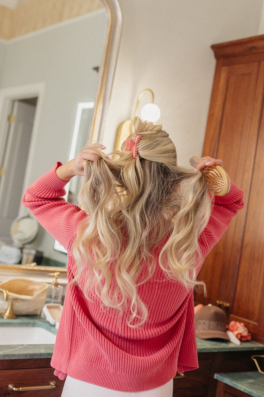 Red mini claw hair clip holding blonde hair up