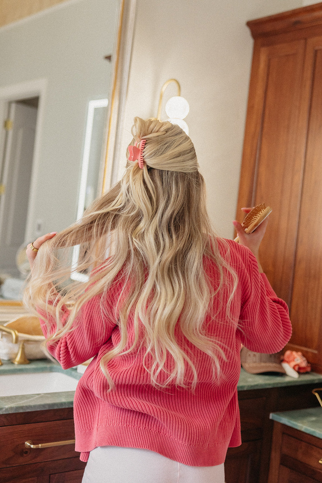 Mini claw hair clip on blonde hair bun, red color