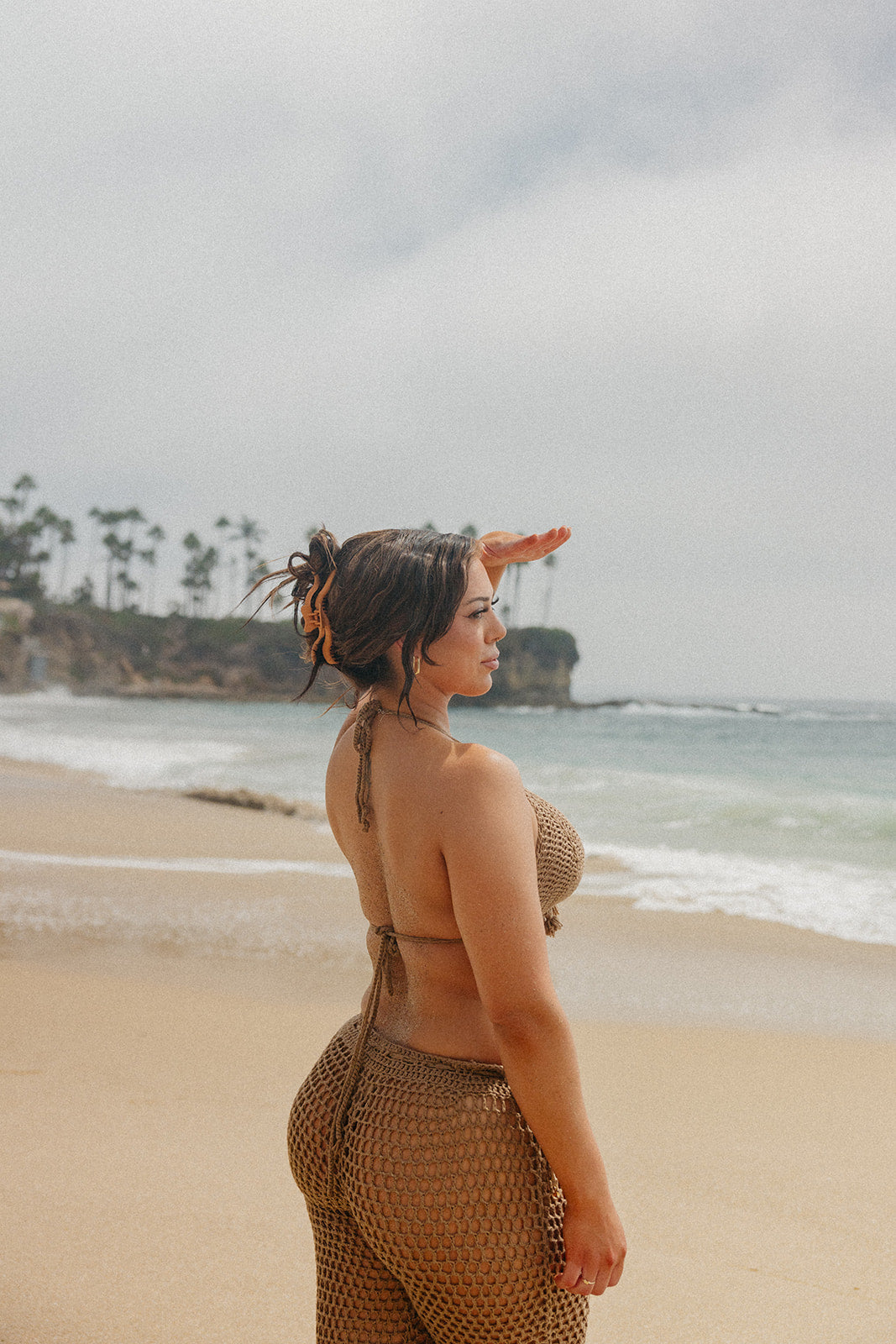 Orange hair claw clip with wavy center and comb teeth holding hair up.