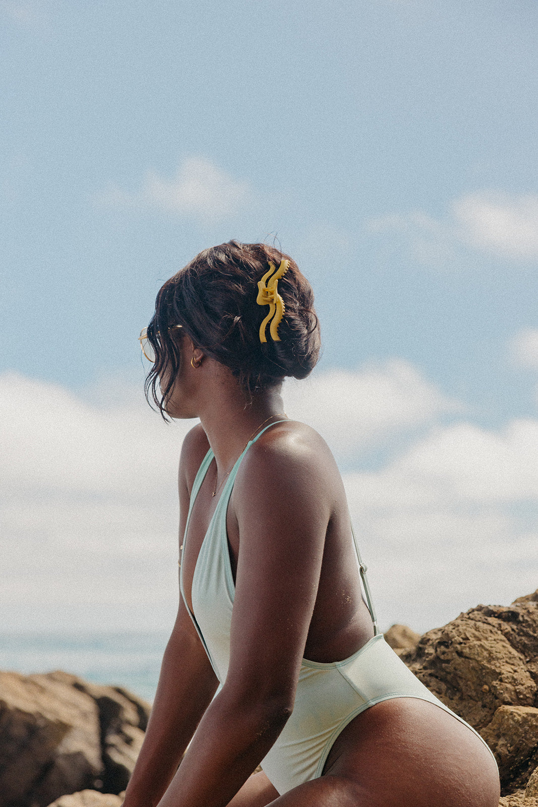 Wavy hold claw hair clip with yellow accents in an updo on dark hair