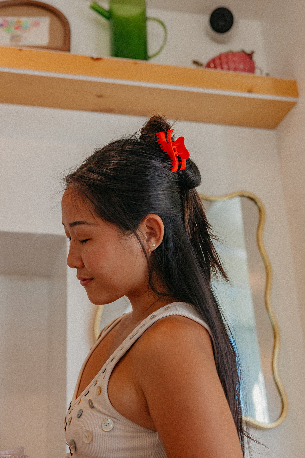 Red wavy mini claw hair clip holding high ponytail