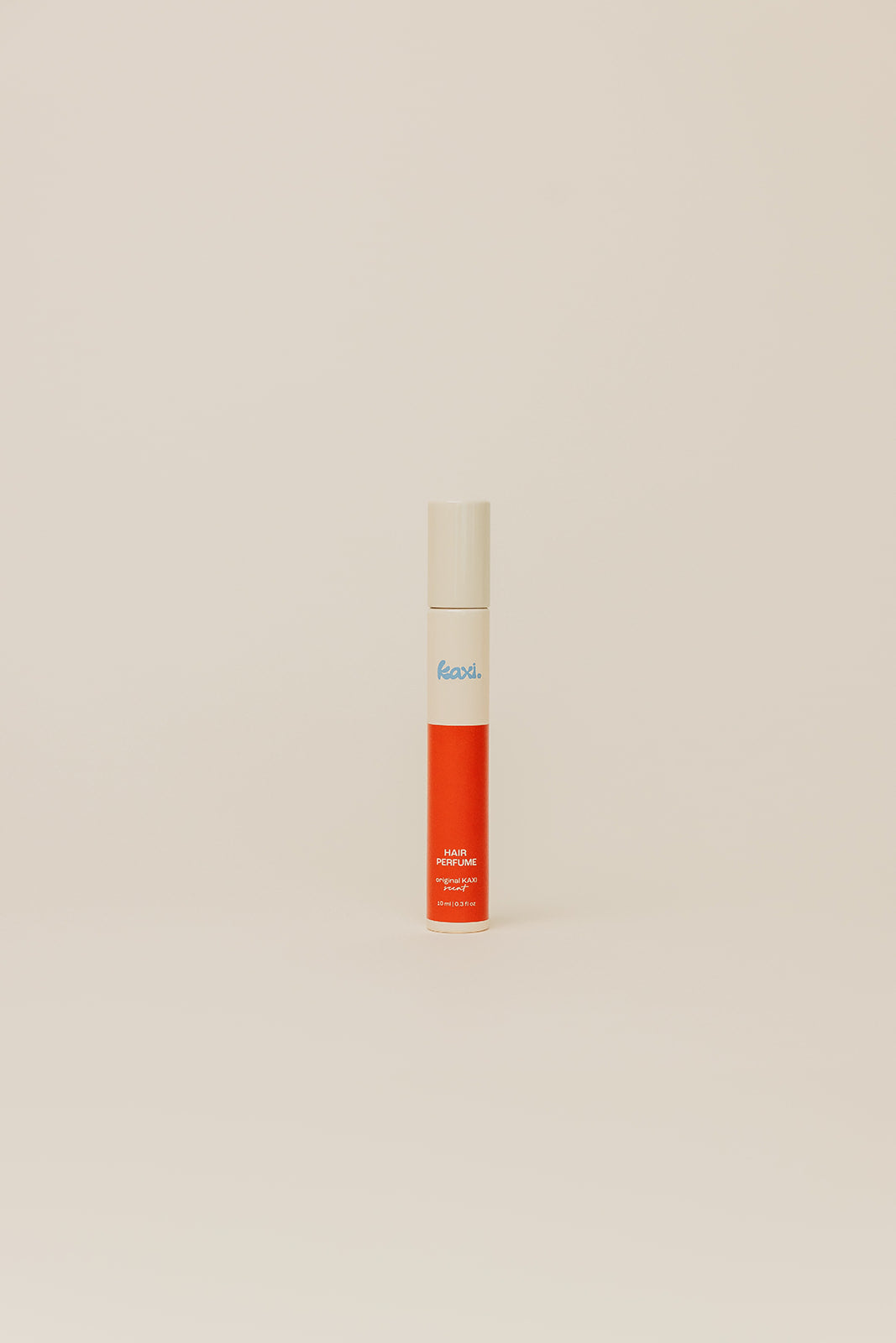 Single hair perfume spray bottle with red label and cream cap on display