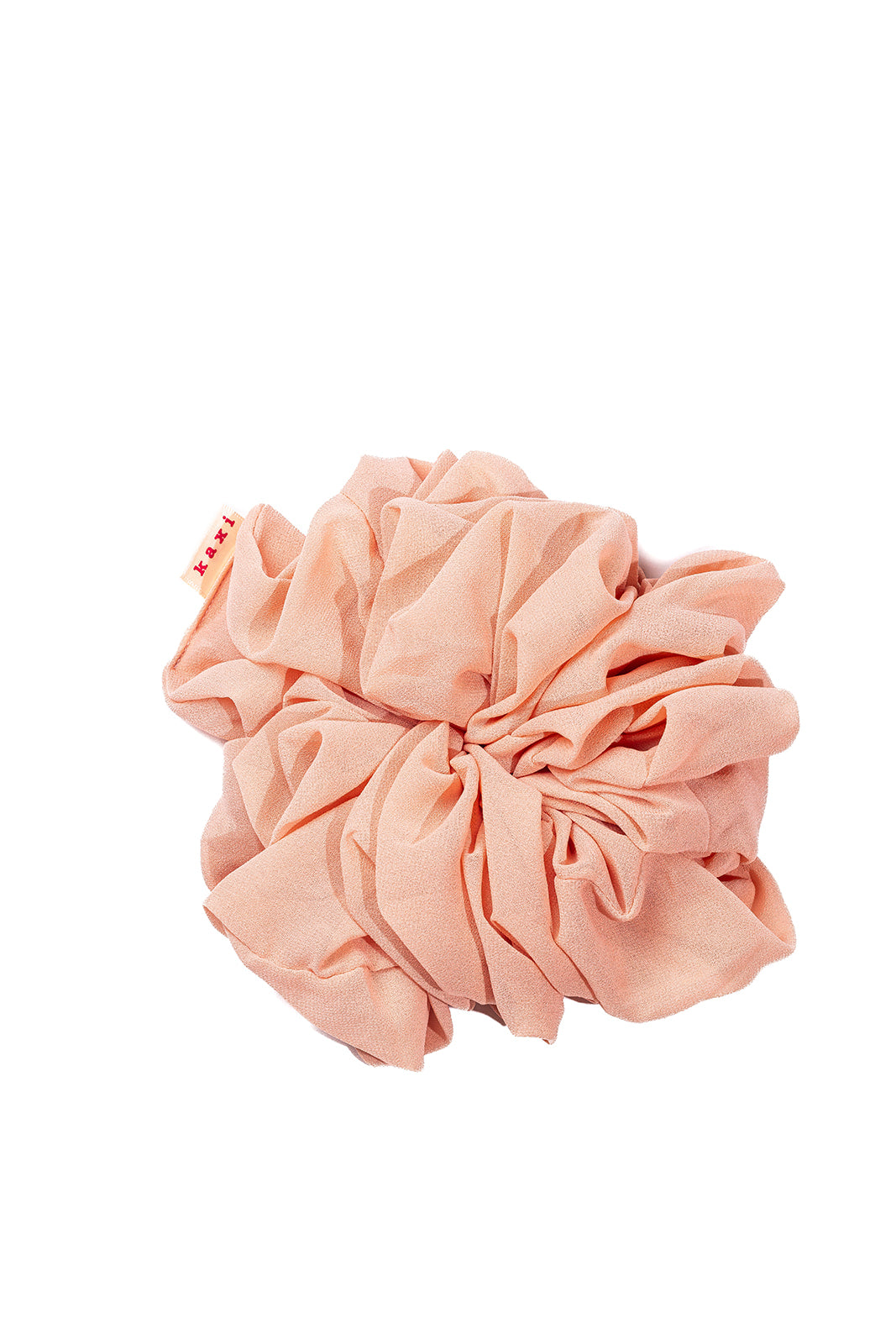 Jumbo scrunchie close-up in coral pink with gathered ruffle texture