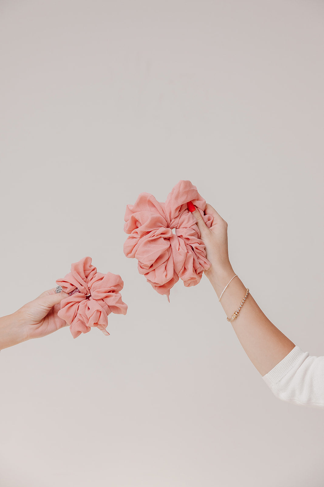 Two jumbo scrunchies in coral pink ruffled flower design